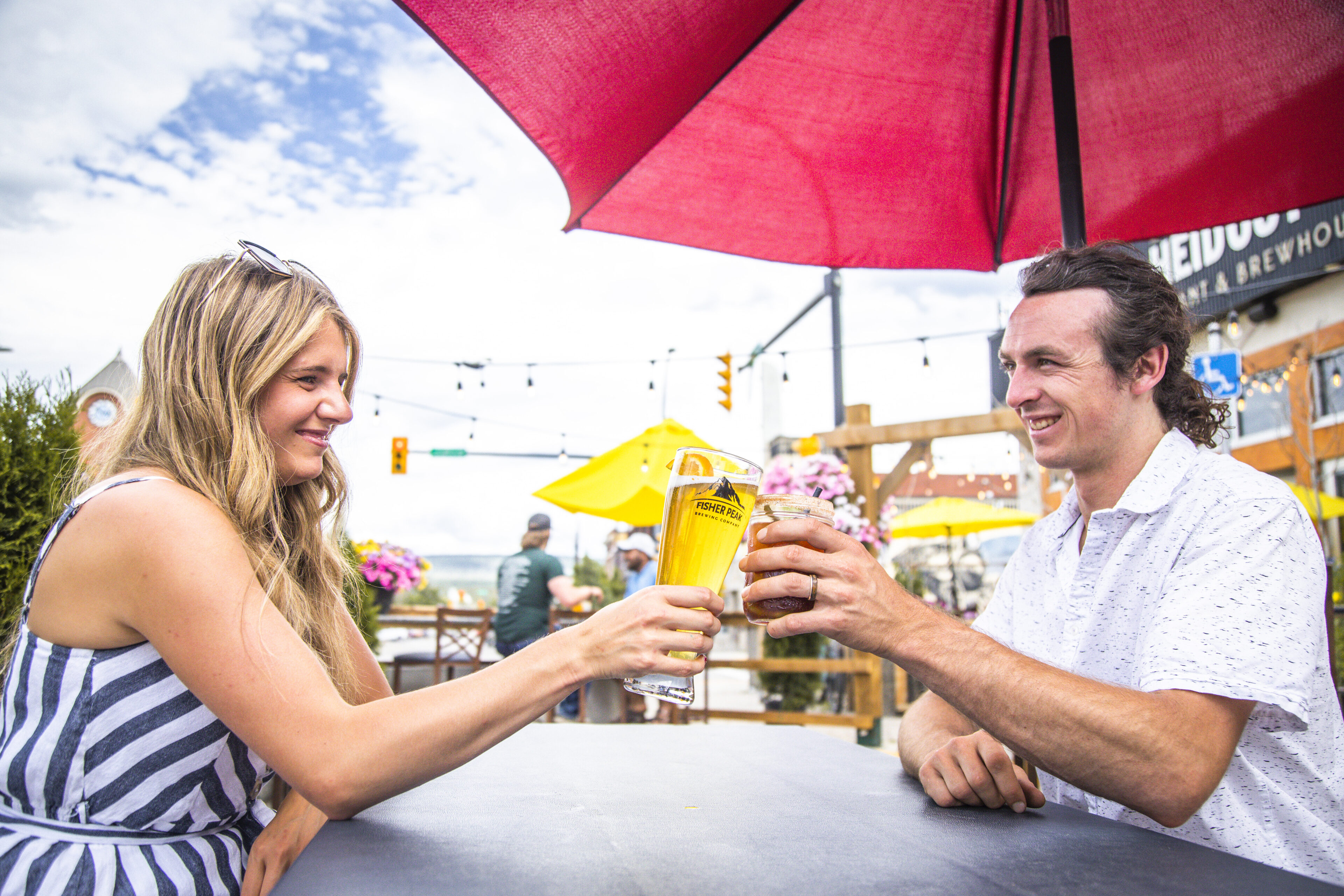 Two people dining on a patio in the summer