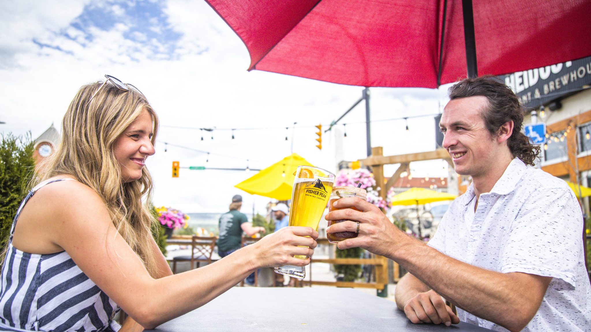 Two people dining on a patio in the summer